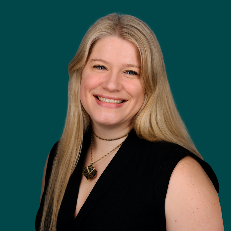 Smile picture of Tiffany wearing a black jumper and D20 necklace